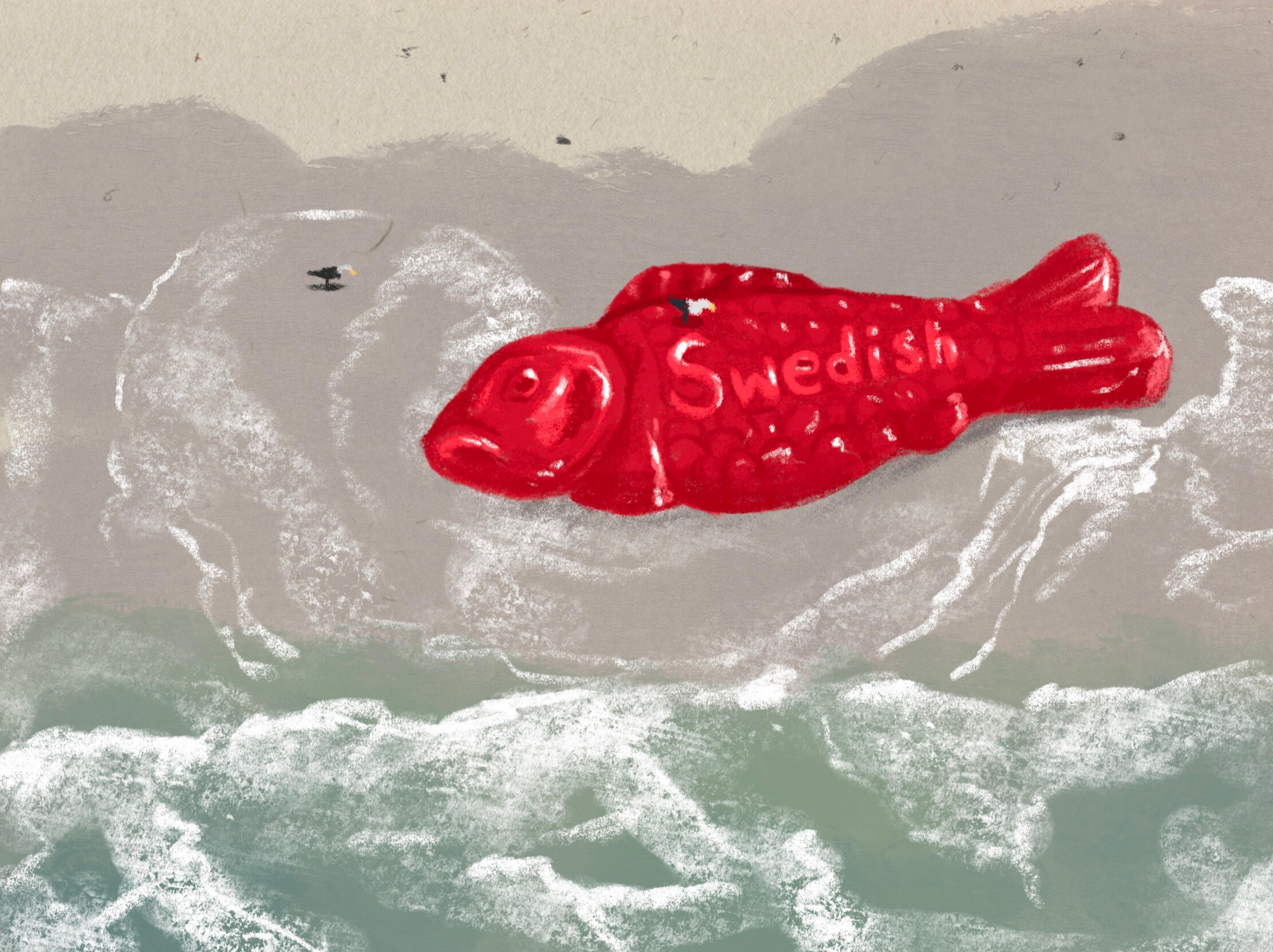 A whale sized Swedish Fish candy piece that has been washed ashore. There are two tiny seagulls around the fish for size comparison.